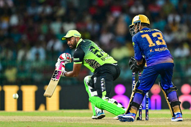 Galle Marvels Bhanuka Rajapaksa plays a shot as Jaffna Kings wicketkeeper Kusal Mendis looks on during the Lanka Premier League final cricket match...