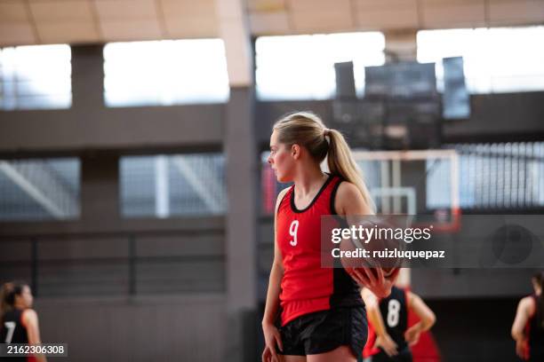 professional female basketball player having training on indoor court - womens basketball stock pictures, royalty-free photos & images