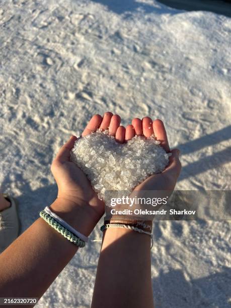 heart made of salt in hands. - crystal stock pictures, royalty-free photos & images