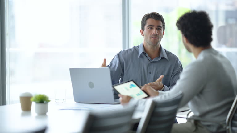 https://media.gettyimages.com/id/2162329881/video/two-businessmen-working-on-a-digital-tablet-and-laptop-computer-in-the-office-a-board-room-or.jpg?b=1&s=640x640&k=20&c=SPqTFfG-L1BpE_DTwhA9i6QlZrA5XG_-_l10FcBVMgg=