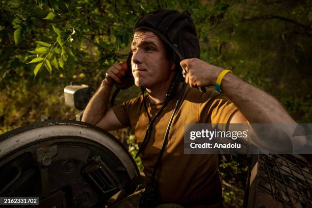 The commander of a -80 tank from the 80th Air assault brigade, puts on his helmet while training in the direction of Chasiv Yar, Ukraine, on July 20,...