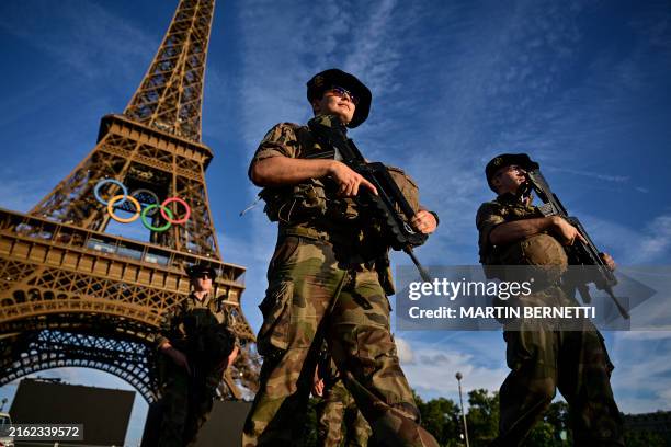 French soldiers stand guard near to Eiffel Tower in Paris on July 21 ahead of the Paris 2024 Olympic and Paralympic Games.