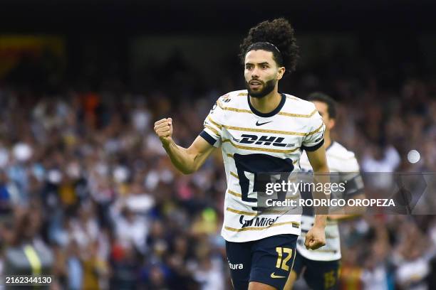 Pumas' forward Cesar Huerta celebrates after scoring a penalty goal during the Liga MX Apertura tournament football match between Pumas and Pachuca...