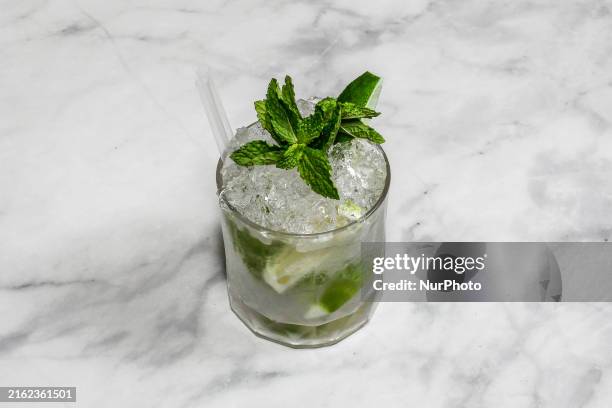 The cocktail ''Caipirinha'' is sitting on a bright background.