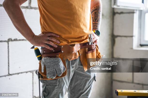 close-up of tool belt on the unrecognisable handyman - handyman stock pictures, royalty-free photos & images