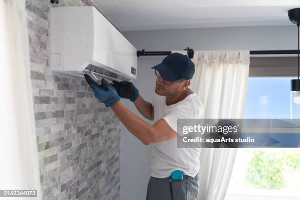repairing air conditioner unit indoor - residential air conditioner service stock pictures, royalty-free photos & images