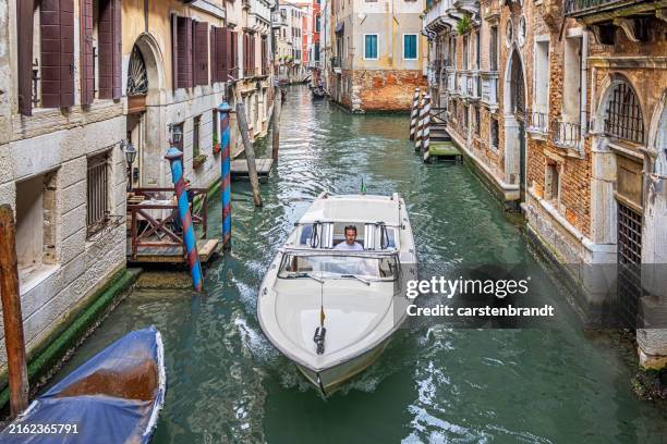 water taxi sailing down a narrow canal - water taxi stock pictures, royalty-free photos & images