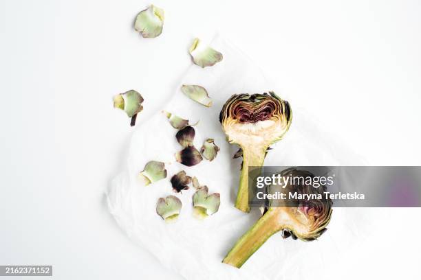 cleaning artichokes before cooking. exotic vegetables. healthy food. farm harvest. dish ingredients. - artichoke stock pictures, royalty-free photos & images