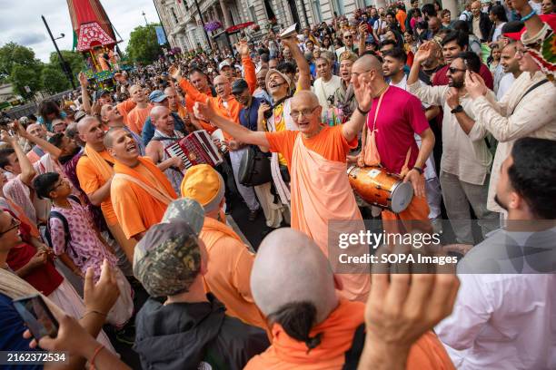 Hare Krishna devotee salutes a crowd during the Rathayatra procession. Thousands of followers of the Hare Krishna religion gather in Central London...