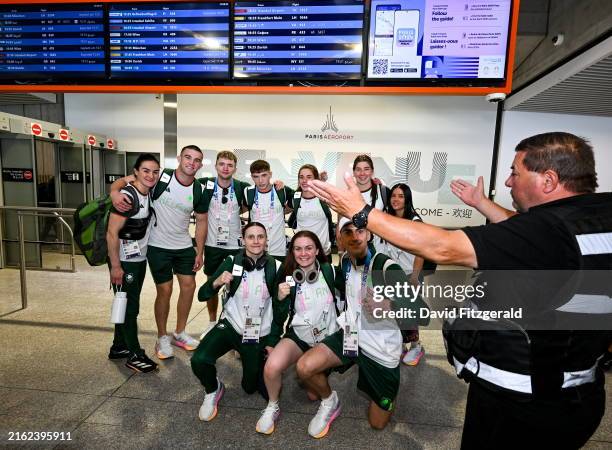 Paris , France - 22 July 2024; Airport security intervenes during a photo of Team Ireland boxers, back row, from left, Kellie Harrington, Jack...