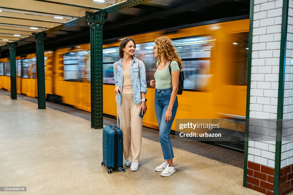 Two Female Friends Waiting For A Subway Train In Budapest In Hungary