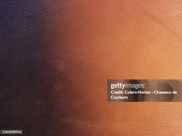 multi colored dots on a black and brown background. close-up of a poster printed in offset in paris, france. natural light and colors. - poster printing stock pictures, royalty-free photos & images