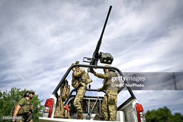 Fighters of the Separate Anti-Aircraft Machine Gun Battalion, who are providing air cover for unmanned aerial vehicles and destroying targets at a...