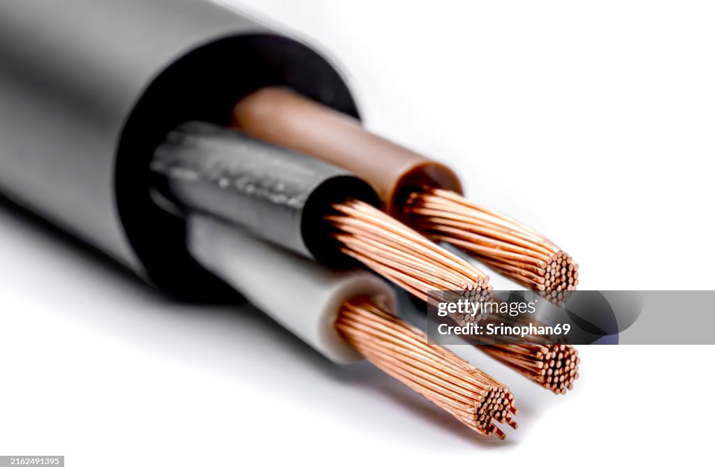 Copper coil isolated on white background Industrial copper wire for electrical applications Shows its conductive properties and engineering utility.