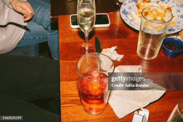 table in a pub with different alcohol drinks - drinking problem stock pictures, royalty-free photos & images