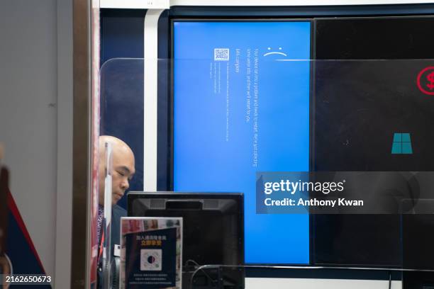 Error blue screen is displayed at a currency exchange store at the Hong Kong International Airport on July 19, 2024 in Hong Kong, China. A...