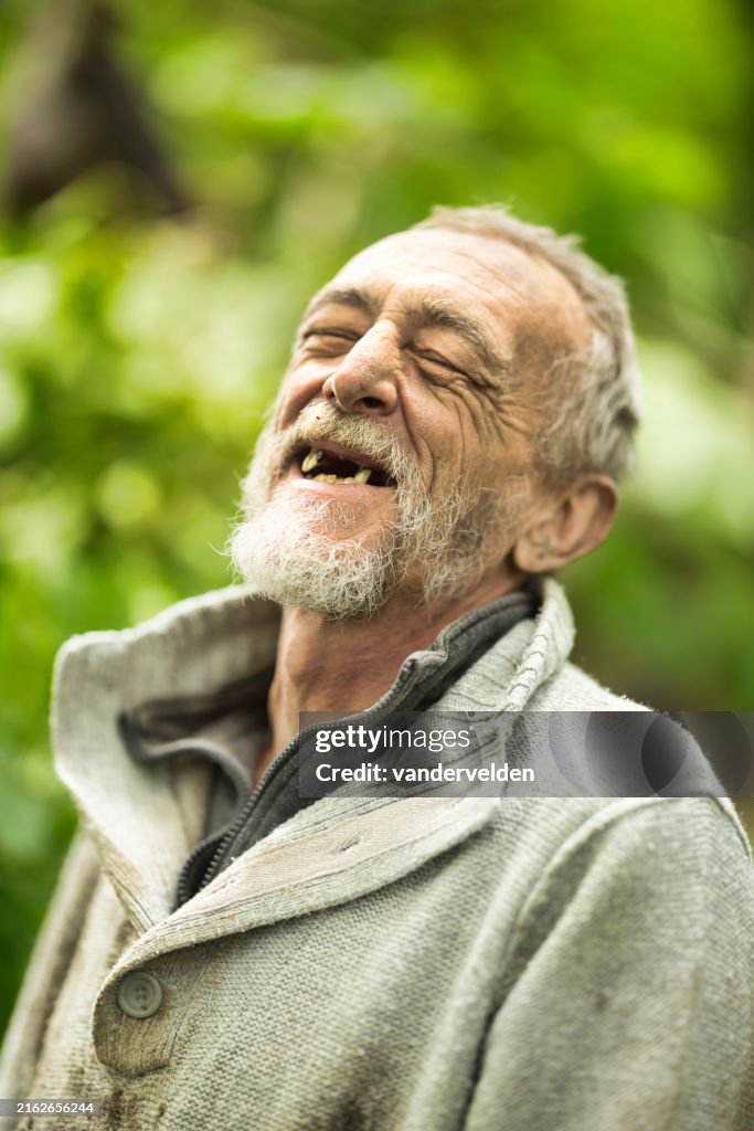 Homeless man living in Summer woodland