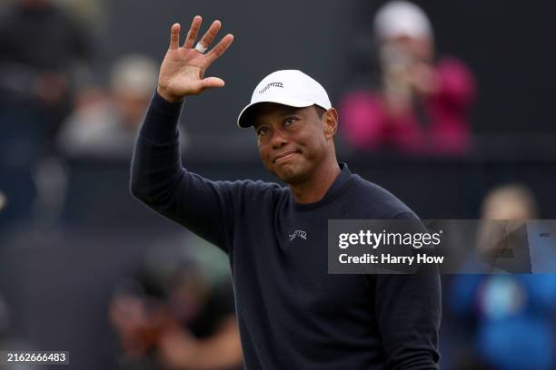 Tiger Woods of the United States acknowledges the crowd as he walks off the 18th green after finishing his round during day two of The 152nd Open...