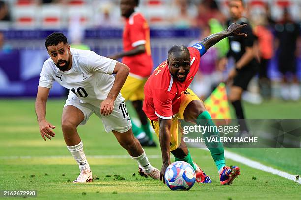 New Zealand's midfielder Sarpreet Singh and Guinea's midfielder Naby Keita vie for the ball in the men's group A football match between Guinea and...