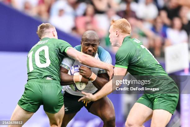 Terry Kennedy of Ireland, Siviwe Soyizwapi of South Africa and Gavin Mullin of Ireland battle for the ball during the men's Rugby Sevens - Pool A...