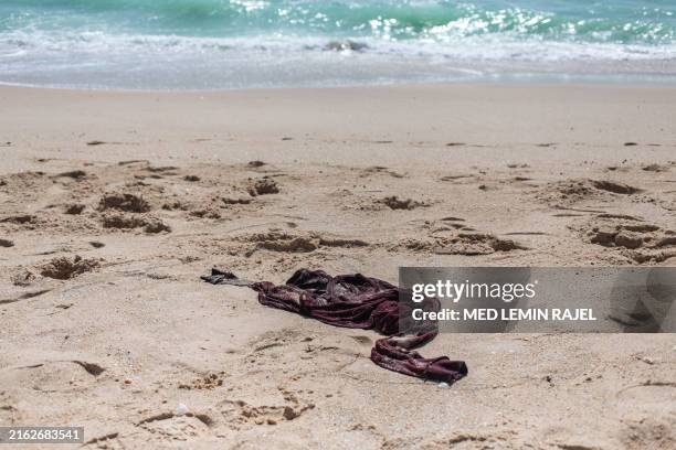 Shirt belonging to a migrant who perished in a shipwreck off the coast of Mauritania is left on a beach outside Nouakchott on July 24, 2024. At least...