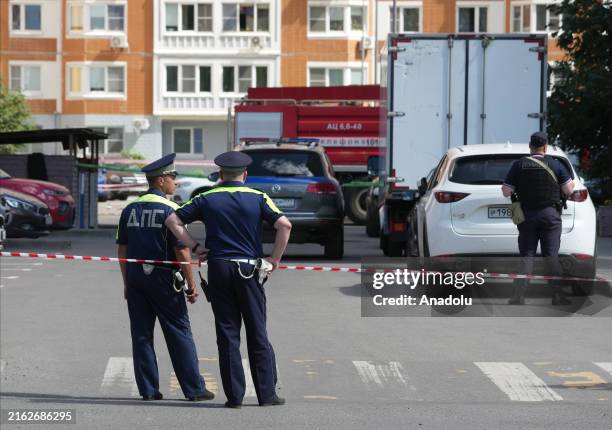 Police teams take security measures at the scene following an explosion on a parked car in which a Russian military personnel and his wife were...