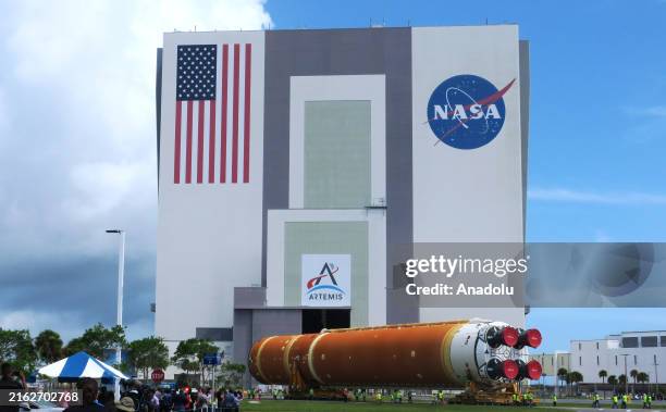 Workers transport the 212-foot-tall SLS core stage for the Artemis II moon rocket into the Vehicle Assembly Building at NASA's Kennedy Space Center...