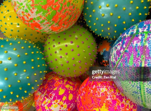 heap of assorted colorful balls - rubber material stock pictures, royalty-free photos & images