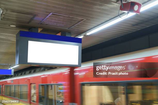 white billboard in the train station platform while the subway train was passing at the station - train billboard stock pictures, royalty-free photos & images