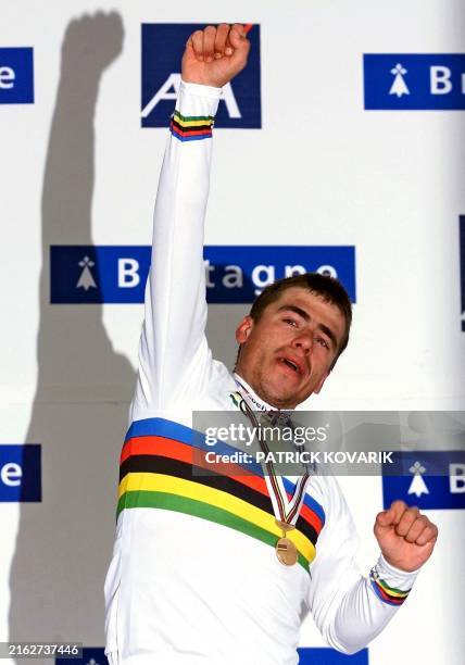 Gold medalist Romans Vainsteins of Latvia raises his fist on the podium of the elite men's individual road race during the 2000 World Road Cycling...