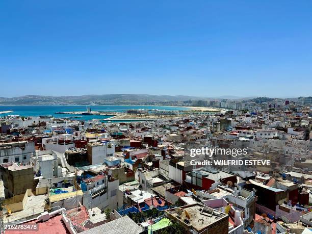 View of the medina, beach and port from the kasbah in the midday sun, Tangier, Morocco, 7 July 2024.