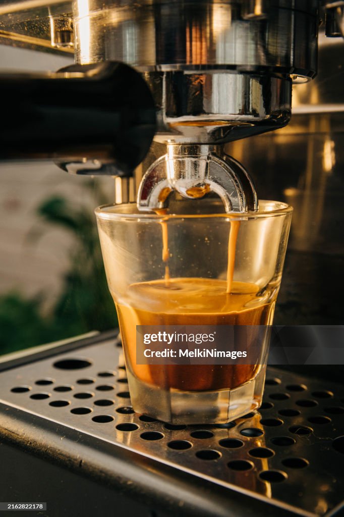 Espresso machine pouring espresso shot into a glass