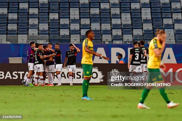 Palestino's Paraguayan forward Junior Marabel celebrates with teammates after scoring his team's first goal during the Copa Sudamericana knockout...
