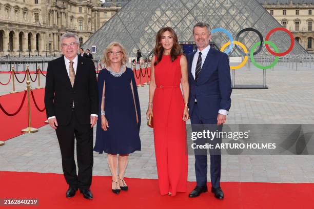 President Thomas Bach , his wife Claudia Bach, and King of Demark Frederik X and Queen Mary of Denmark upon their arrival at the Pyramide du Louvre,...