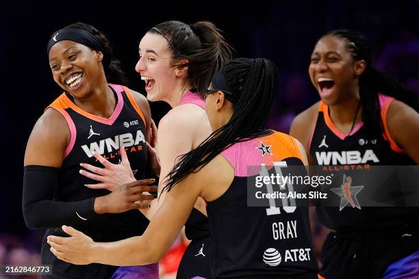 Arike Ogunbowale celebrates a three point basket with Caitlin Clark and Allisha Gray of Team WNBA in the second half against Team USA during the 2024...
