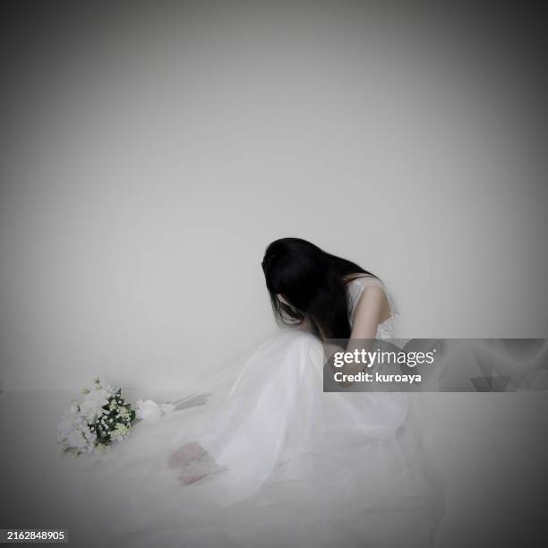 depressed woman who is covering her face sitting on the floor - sitting on ground stock pictures, royalty-free photos & images