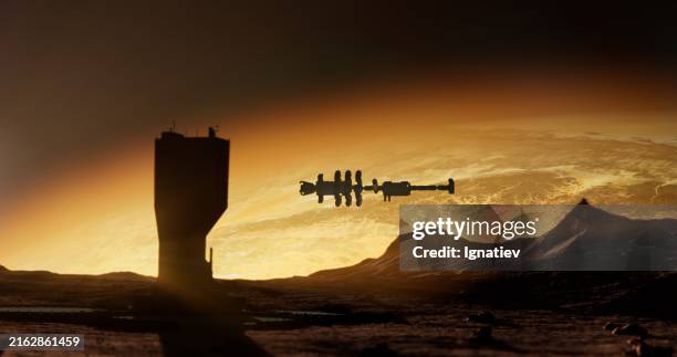 a tall building on mars with a spaceship and bright horizon - space debris stock pictures, royalty-free photos & images