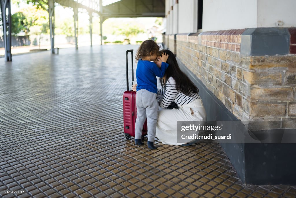 Asian family traveler waiting the train