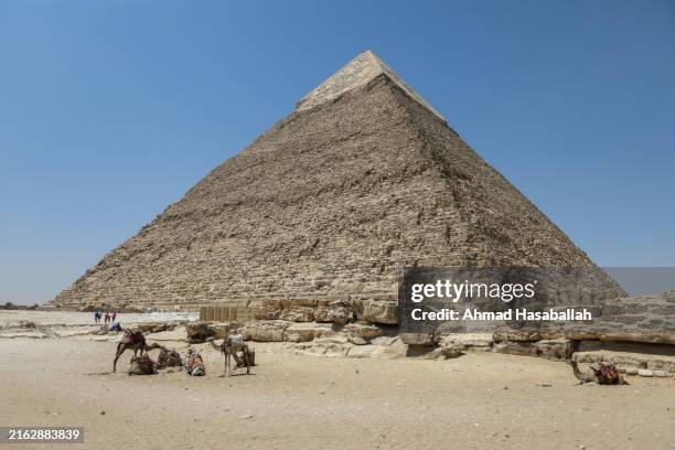 Tourists walk past the pyramids of Khufu, Khafre, and Menkaure on July 21, 2024 in Giza, Egypt. The colossal tombs near Cairo, built around 4,500...
