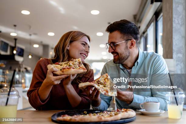 pizza date for couple in cozy setting - pizza restaurant stock pictures, royalty-free photos & images