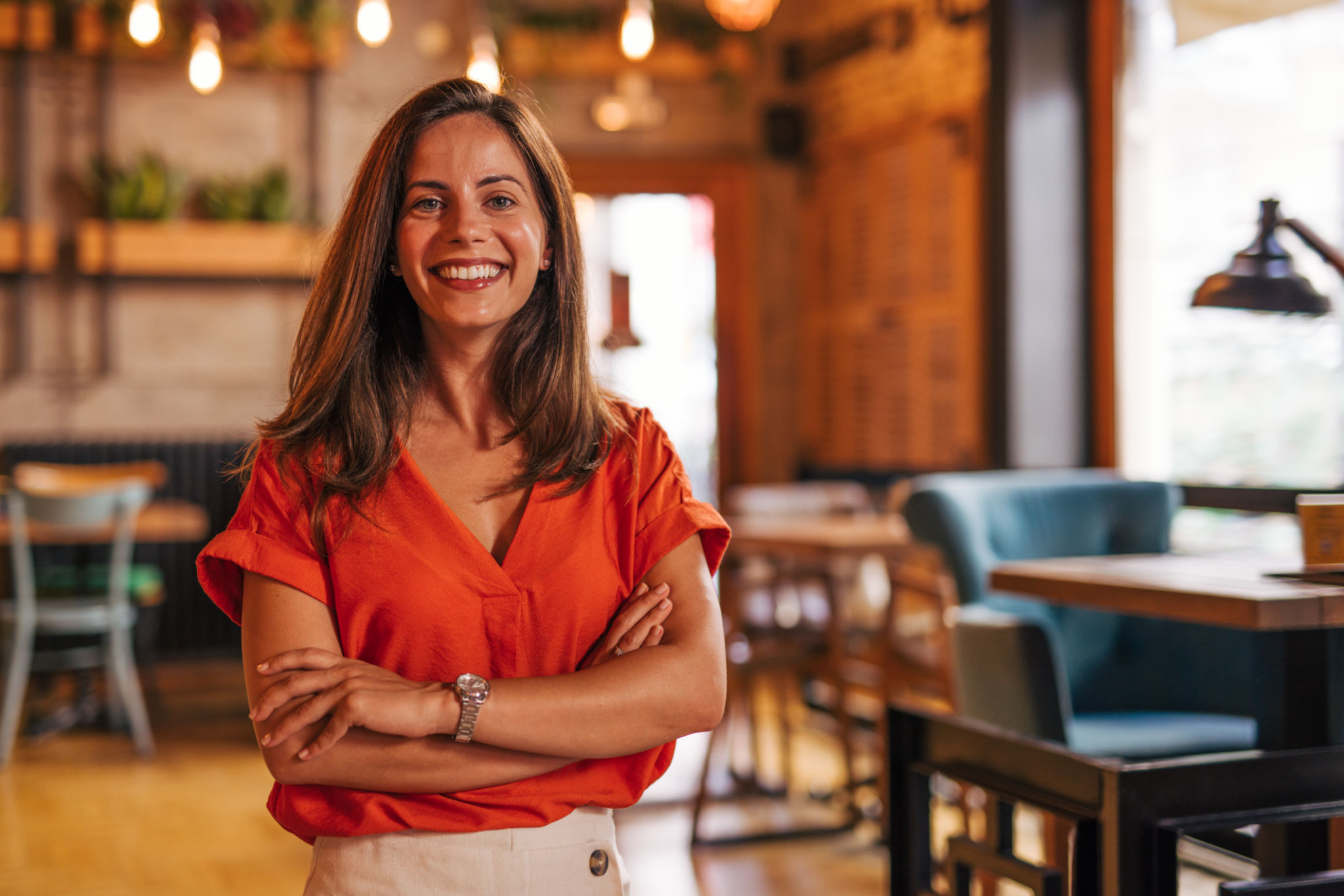 Portrait of a young woman standing in cafeteria, she is the owner. A successful small business owner. Portrait of a young woman standing in cafeteria, she is the owner. A successful small business owner.