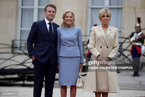 France's President Emmanuel Macron and his wife Brigitte Macron greet US First Lady Jill Biden on arrival ahead of a reception for heads of state and...