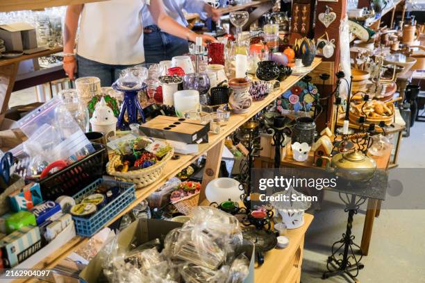 secondhand sale of various stuff in a barn - kringloopwinkel stockfoto's en -beelden