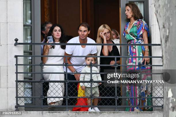 Spain's tennis player Rafael Nadal , his mother Ana Maria Parera , wife Maria Francisca Perello , and their son Rafa Junior watch from a balcony the...