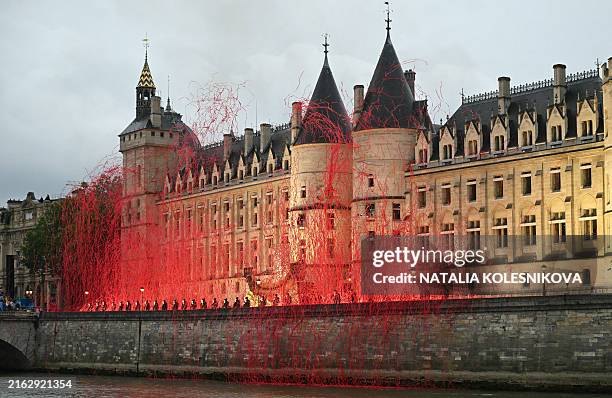 Headless figures depicting the 18th century Queen Marie Antoinette perform along the Seine river embankment outside the Conciergerie, where the queen...