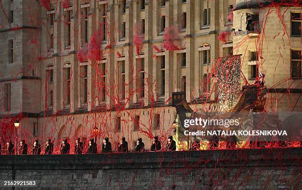 Headless figures depicting the 18th century Queen Marie Antoinette perform along the Seine river embankment outside the Conciergerie, where the queen...