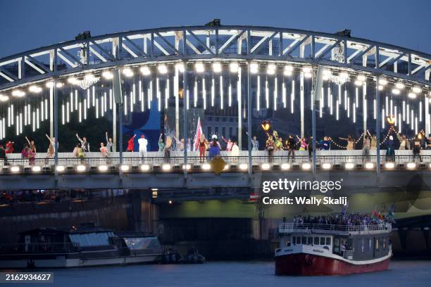 Performers and models at a catwalk erected along the Passerelle Debilly bridge on the Seine river during the opening ceremony of the 2024 Summer...