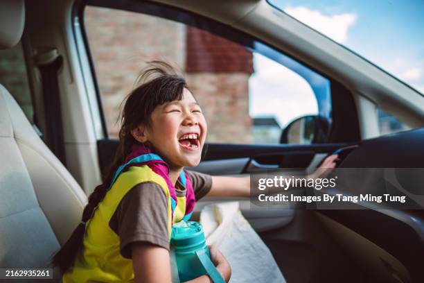 young cheerful girl laughing joyfully inside a car - asian girl driving stock pictures, royalty-free photos & images