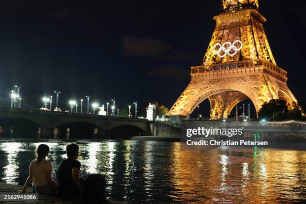 Spectators view the Eiffel Tower and Olympic rings along the Seine river on July 21, 2024 in Paris, France. The city is gearing up to host the XXXIII...