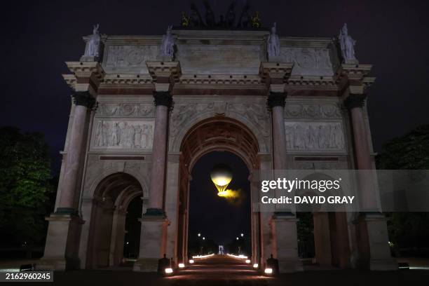 The cauldron, with the Olympic flame lit, lifts off while attached to a balloon, during the opening ceremony of the Paris 2024 Olympic Games in Paris...